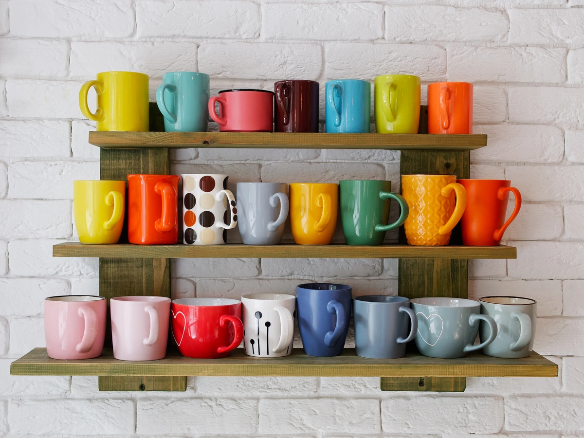 colorful coffee mugs on the open kitchen shelf