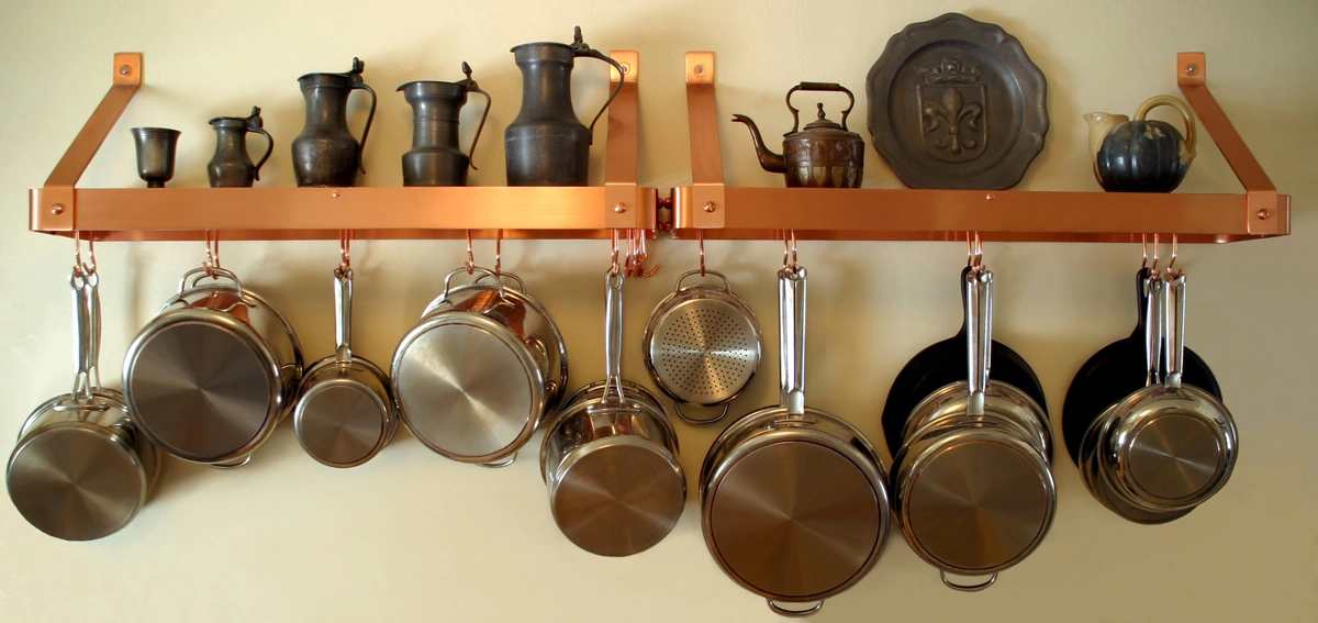 hanging pots and pans on the kitchen shelf